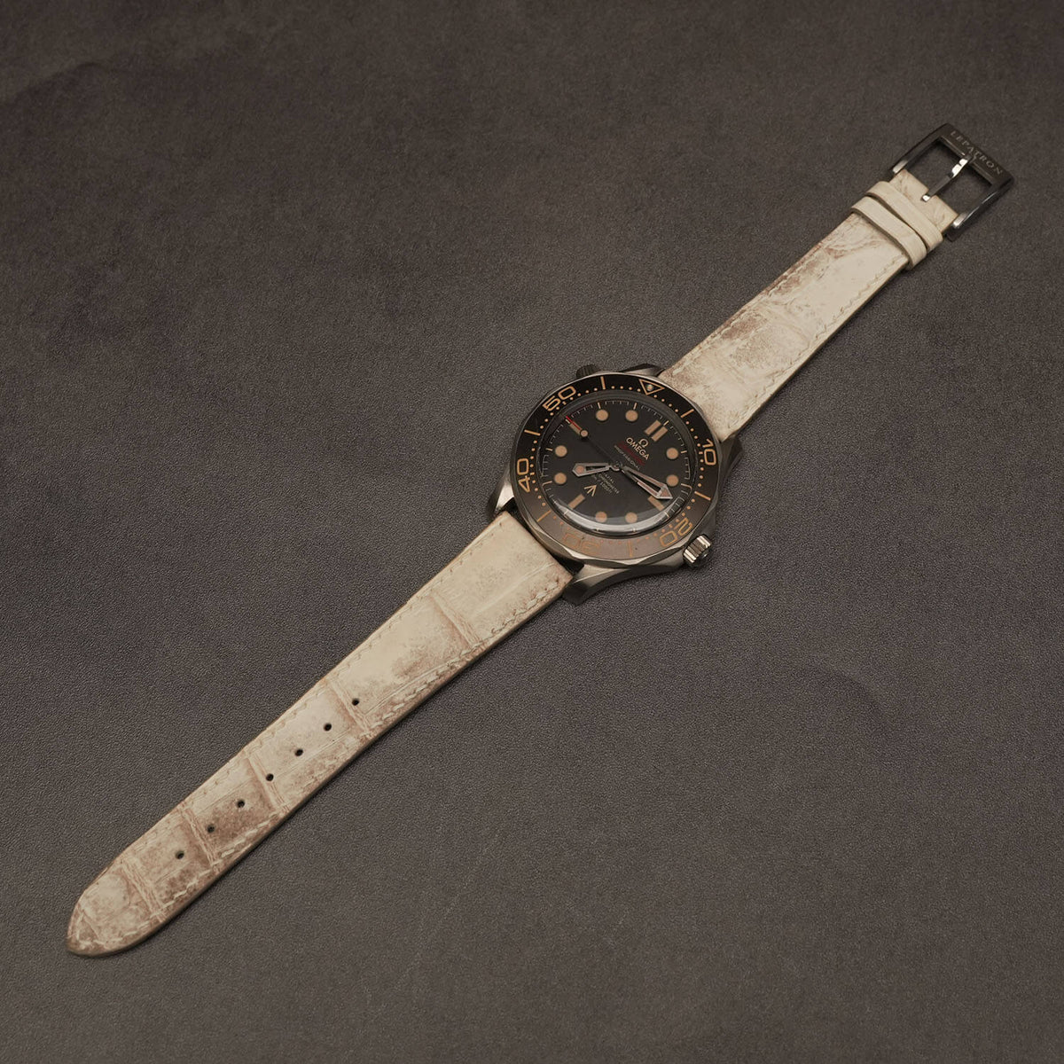 Handcrafted Himalayan crocodile leather watch strap mounted on a luxury titanium dive watch with a matte black dial and contrasting bezel.