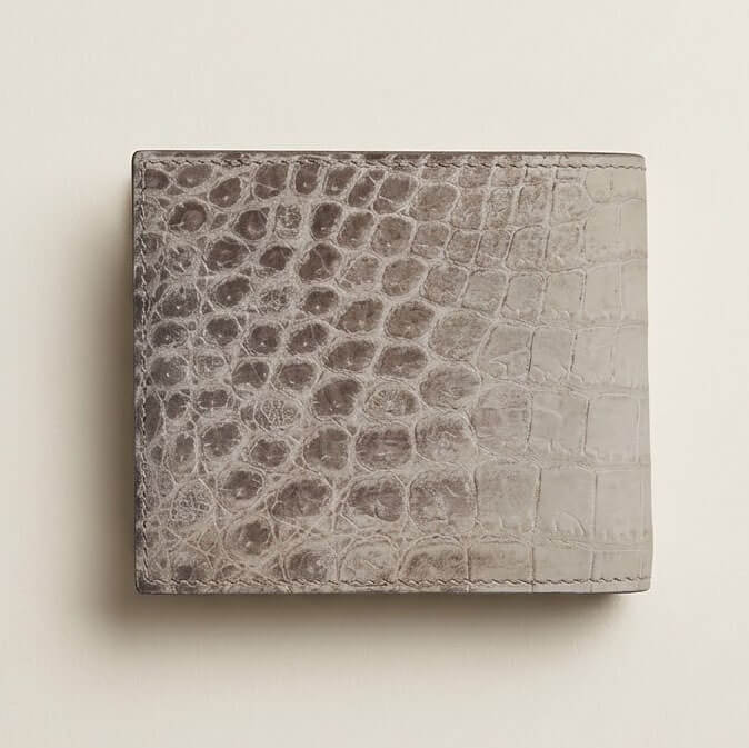 Back panel of the bespoke Himalayan crocodile bifold wallet, highlighting organic circular scale patterning and hand-finished matte painted edges.