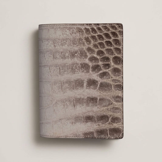 Front view of a closed bespoke passport cover showcasing the natural white-to-grey gradient of matte French Himalayan crocodile leather with hand-painted edges.