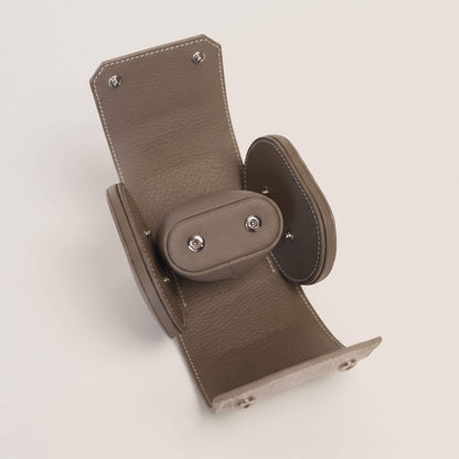 fully opened watch case interior lined with Étoupe French Alran goatskin, showing the removable cushion and silver-plated brass snaps.